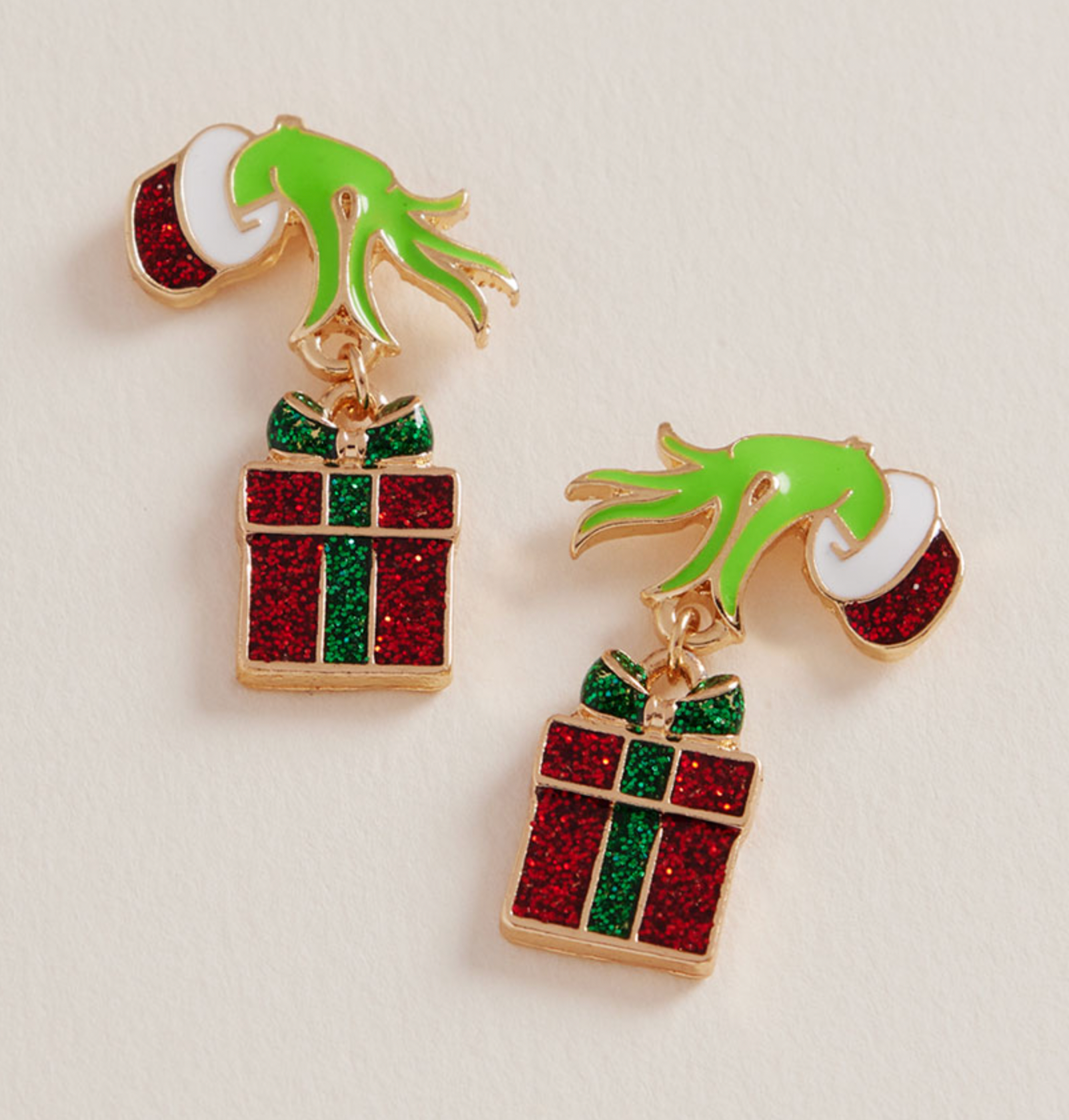 Grinch Hand Holding Red Present